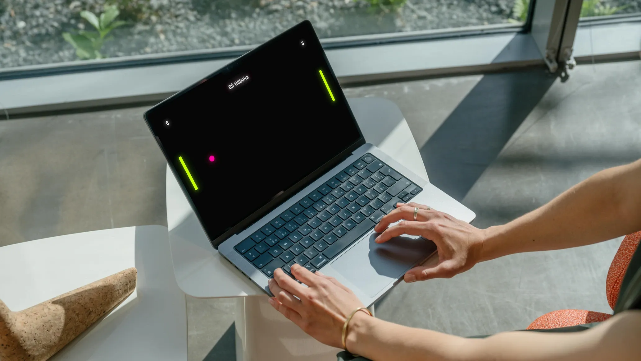 Person playing Pong on a macbook